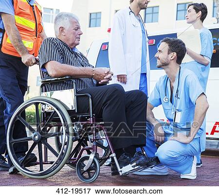 Nurse talking to patient outside ambulance View Large Photo Image Stock Photo - Nurse talking to patient outside ambulance. Fotosearch