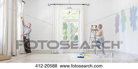 Older couple hanging curtains together View Large Photo Image Stock Photo - Older couple hanging curtains together. Fotosearch