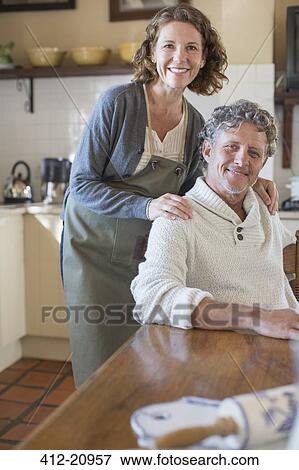 Stock Photo - Older couple relaxing in the kitchen. Fotosearch