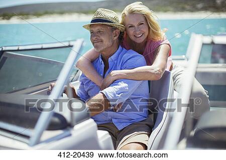 Stock Photo - Older couple relaxing on boat . Fotosearch
