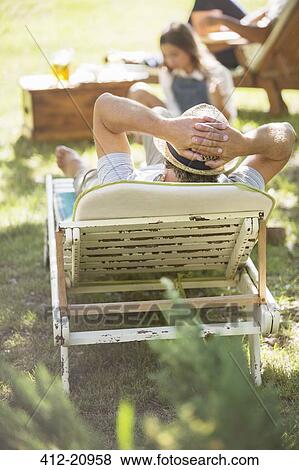 Stock Photo - Older man relaxing on lawn chair. Fotosearch
