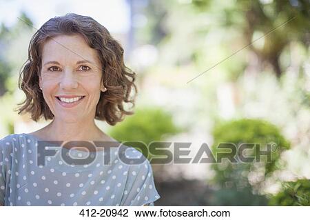 Older woman smiling outdoors View Large Photo Image Stock Image - Older woman smiling outdoors. Fotosearch