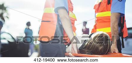 Paramedics carrying patient on stretcher outdoors View Large Photo Image Stock Image - Paramedics carrying patient on stretcher outdoors. Fotosearch