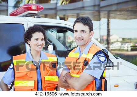 Paramedics smiling outside ambulance View Large Photo Image Stock Photograph - Paramedics smiling outside ambulance. Fotosearch