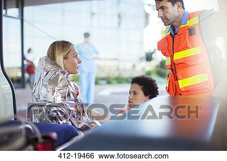 Paramedics talking to patient in ambulance View Large Photo Image Stock Photograph - Paramedics talking to patient in ambulance. Fotosearch