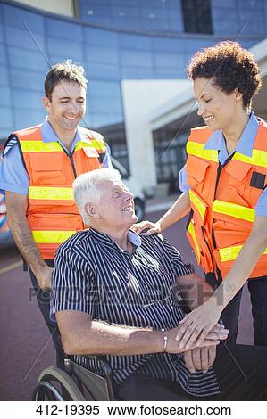 Paramedics talking to patient outside hospital View Large Photo Image Stock Photography - Paramedics talking to patient outside hospital. Fotosearch