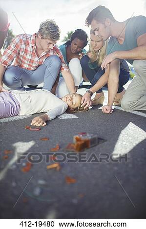 People examining injured girl on street View Large Photo Image Stock Image - People examining injured girl on street. Fotosearch