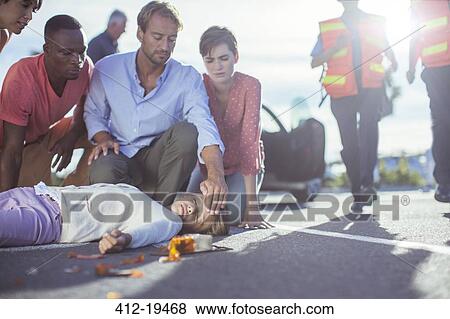 People examining injured girl on street View Large Photo Image Stock Photo - People examining injured girl on street. Fotosearch