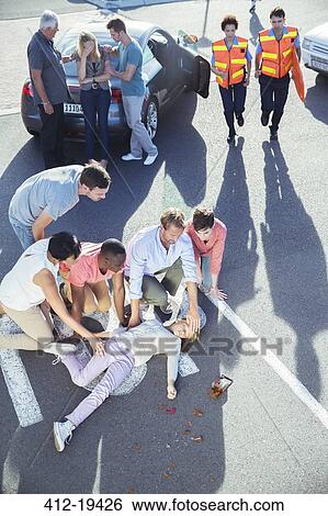 People examining injured girl on street View Large Photo Image Stock Photograph - People examining injured girl on street. Fotosearch