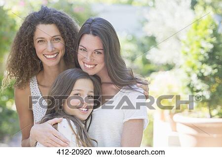Sisters hugging outdoors View Large Photo Image Stock Image - Sisters hugging outdoors. Fotosearch