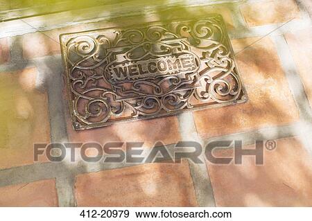 Sun shining through tree branches on welcome mat View Large Photo Image Stock Photo - Sun shining through tree branches on welcome mat . Fotosearch