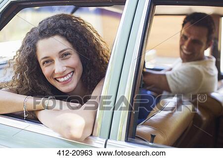 Woman relaxing on car door during car ride View Large Photo Image Stock Image - Woman relaxing on car door during car ride. Fotosearch