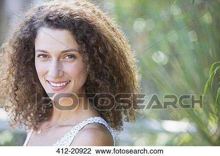 Woman smiling outdoors View Large Photo Image Stock Image - Woman smiling outdoors. Fotosearch