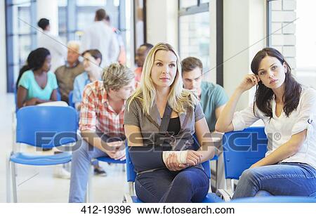 Stock Photograph - Women sitting in hospital waiting room. Fotosearch