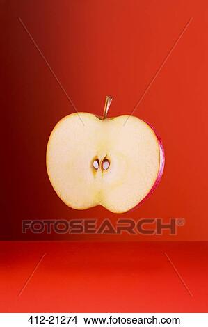 Apple slice on red counter View Large Photo Image Picture - Apple slice on red counter. Fotosearch