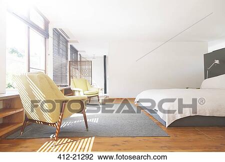 Armchairs, rug and bed in modern bedroom View Large Photo Image Stock Image - Armchairs, rug and bed in modern bedroom. Fotosearch