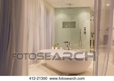 Stock Image - Bathtub and shower in modern bathroom. Fotosearch