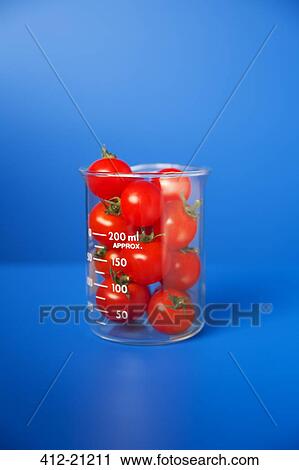 Beaker of small tomatoes on blue counter View Large Photo Image Stock Image - Beaker of small tomatoes on blue counter. Fotosearch