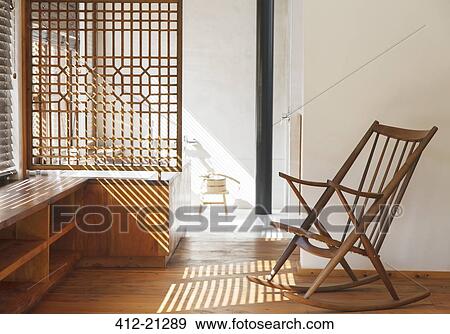 Stock Photo - Blinds casting shadows in modern bedroom. Fotosearch