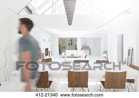 Blurred view of man walking in modern dining room View Large Photo Image Stock Image - Blurred view of man walking in modern dining room. Fotosearch