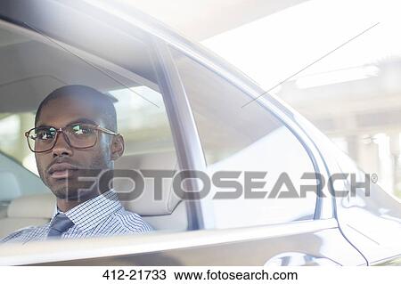 Business man sitting in car back seat View Large Photo Image Stock Image - Business man sitting in car back seat. Fotosearch