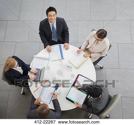 Business people having meeting at table View Large Photo Image Stock Photo - Business people having meeting at table. Fotosearch