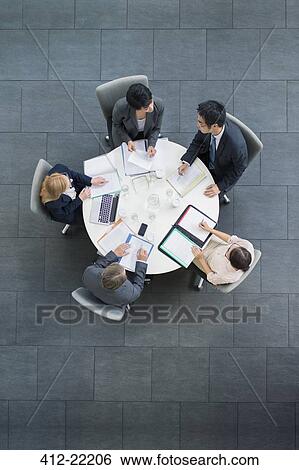Business people having meeting at table View Large Photo Image Stock Photograph - Business people having meeting at table. Fotosearch
