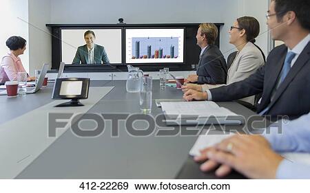 Stock Photo - Business people having teleconference meeting. Fotosearch
