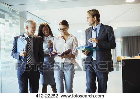Business people talking and walking through office building View Large Photo Image Stock Image - Business people talking and walking through office building. Fotosearch