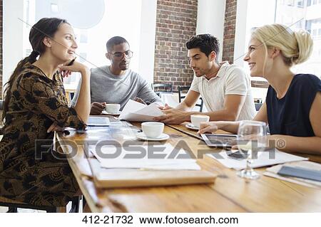 Business people talking at meeting in cafe View Large Photo Image Stock Image - Business people talking at meeting in cafe. Fotosearch