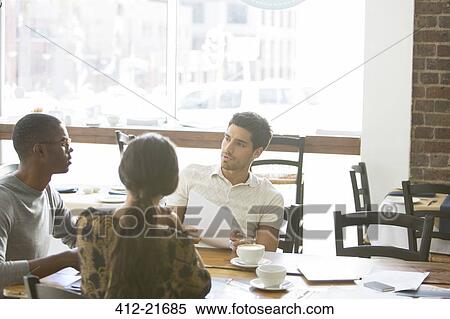 Business people talking at meeting in cafe View Large Photo Image Stock Photography - Business people talking at meeting in cafe. Fotosearch