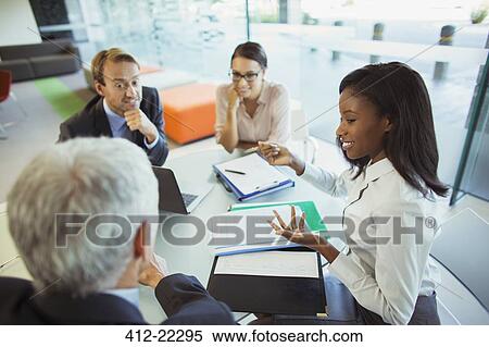 Business people talking at table in office building View Large Photo Image Stock Photography - Business people talking at table in office building. Fotosearch