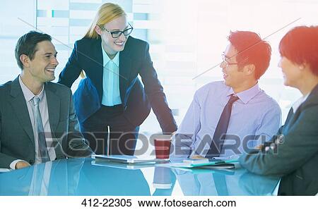 Business people talking at table in office building View Large Photo Image Stock Photography - Business people talking at table in office building. Fotosearch