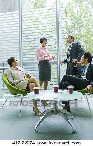 Business people talking in office building View Large Photo Image Picture - Business people talking in office building. Fotosearch