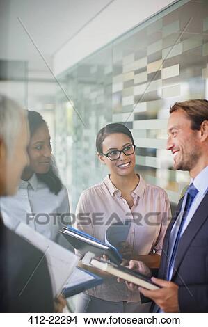 Picture - Business people talking in office building. Fotosearch