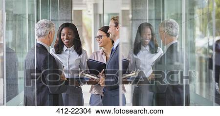 Business people talking in office building View Large Photo Image Picture - Business people talking in office building. Fotosearch