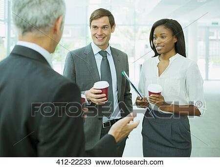 Business people talking in office building View Large Photo Image Stock Image - Business people talking in office building. Fotosearch