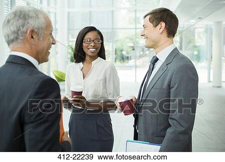 Business people talking in office building View Large Photo Image Stock Photo - Business people talking in office building. Fotosearch