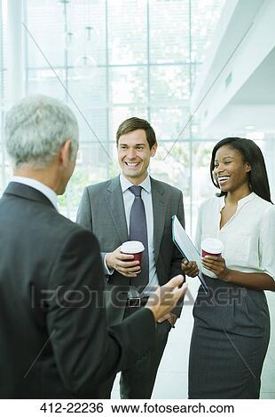 Business people talking in office building View Large Photo Image Stock Photograph - Business people talking in office building. Fotosearch