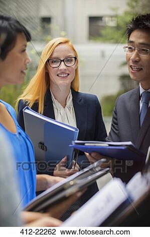 Business people talking outside of office building View Large Photo Image Stock Image - Business people talking outside of office building. Fotosearch