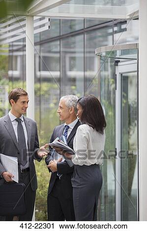 Business people talking outside of office building View Large Photo Image Stock Image - Business people talking outside of office building. Fotosearch