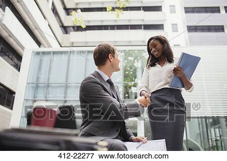 Business people talking outside of office building View Large Photo Image Stock Photo - Business people talking outside of office building. Fotosearch