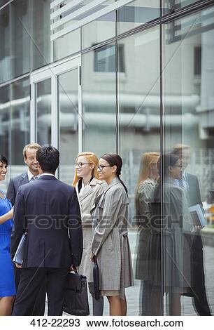 Business people talking outside office building View Large Photo Image Stock Image - Business people talking outside office building. Fotosearch