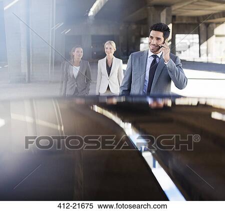 Stock Photography - Business people walking in parking garage. Fotosearch