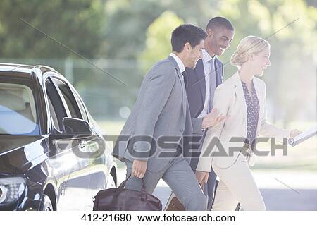 Business people walking together on city street View Large Photo Image Stock Image - Business people walking together on city street. Fotosearch