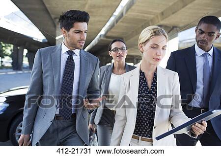 Business people walking under city overpass View Large Photo Image Stock Image - Business people walking under city overpass. Fotosearch