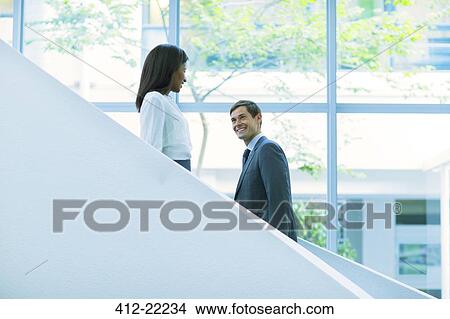 Business people walking up and down the office building stairs View Large Photo Image Picture - Business people walking up and down the office building stairs. Fotosearch