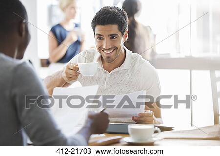 Businessman drinking coffee at meeting in cafe View Large Photo Image Stock Image - Businessman drinking coffee at meeting in cafe . Fotosearch