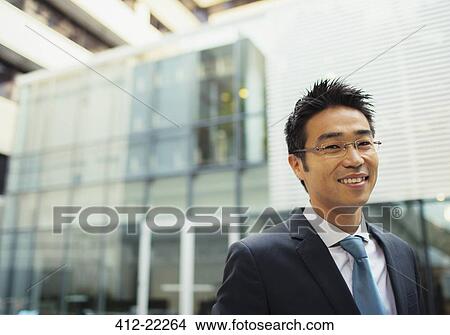 Businessman outside of office building View Large Photo Image Picture - Businessman outside of office building. Fotosearch