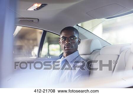 Businessman sitting in car back seat View Large Photo Image Stock Photo - Businessman sitting in car back seat. Fotosearch